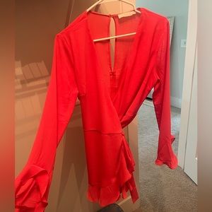 Coral/ pink long sleeve romper with a wrapped tie. Gently used. Size medium
